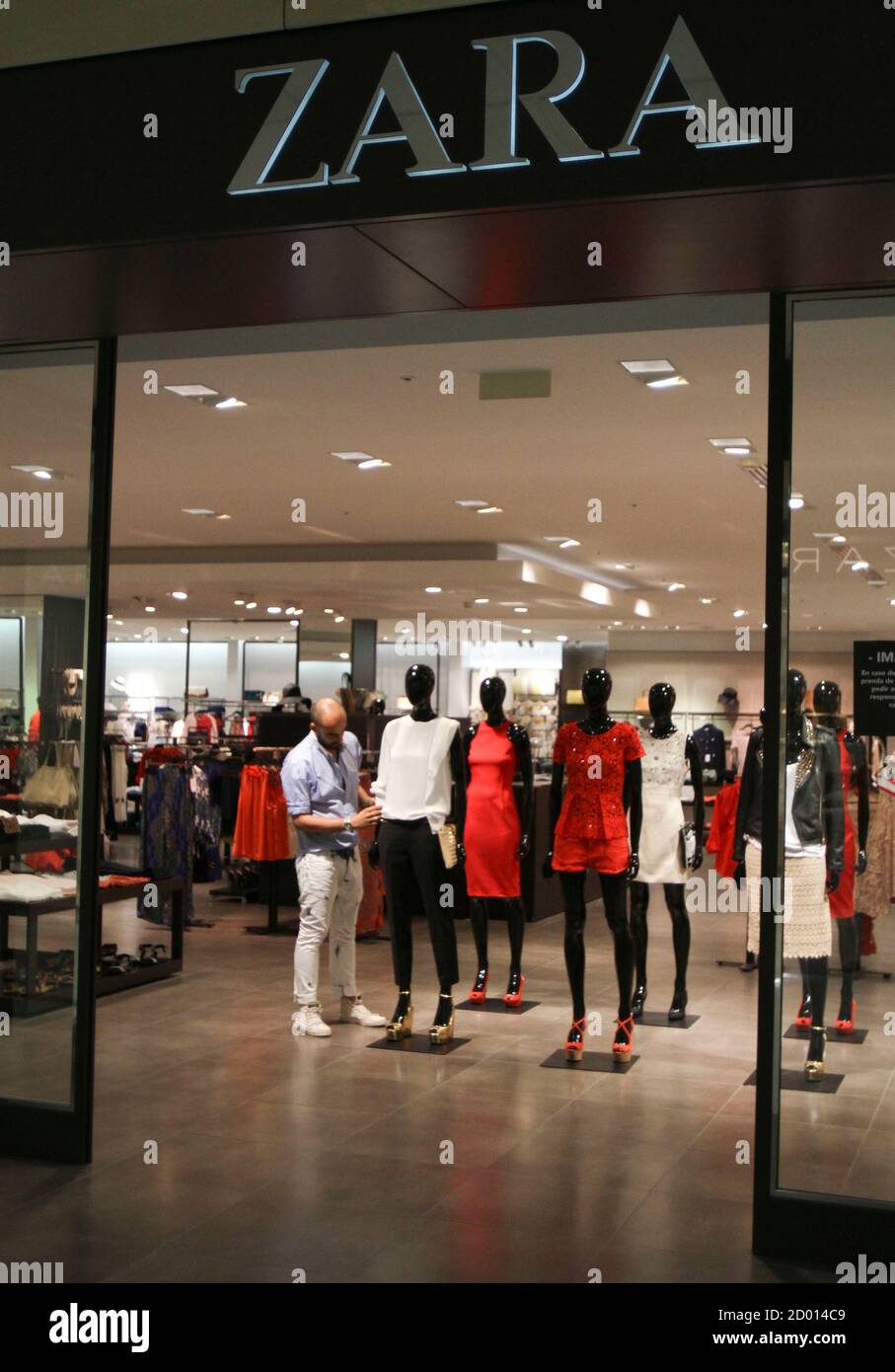 A worker dresses a mannequin in a pilot shop at the Zara factory at the  headquarters of Inditex group in Arteixo, northern Spain, June 14, 2012.  Spain's Inditex SA, the world's largest