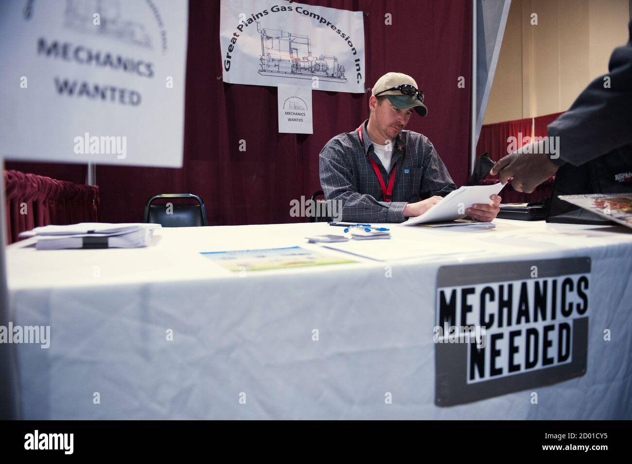 Tom Tow, a field foreman for Great Plains Gas Compression, looks at an application at a job fair in Williston, North Dakota March 11, 2015. REUTERS/Andrew Cullen    (UNITED STATES - Tags: BUSINESS EMPLOYMENT) Stock Photo