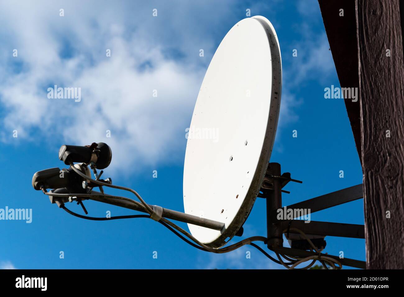 Satellite dish on the house. The digital television channel receiver and transmitter. Stock Photo