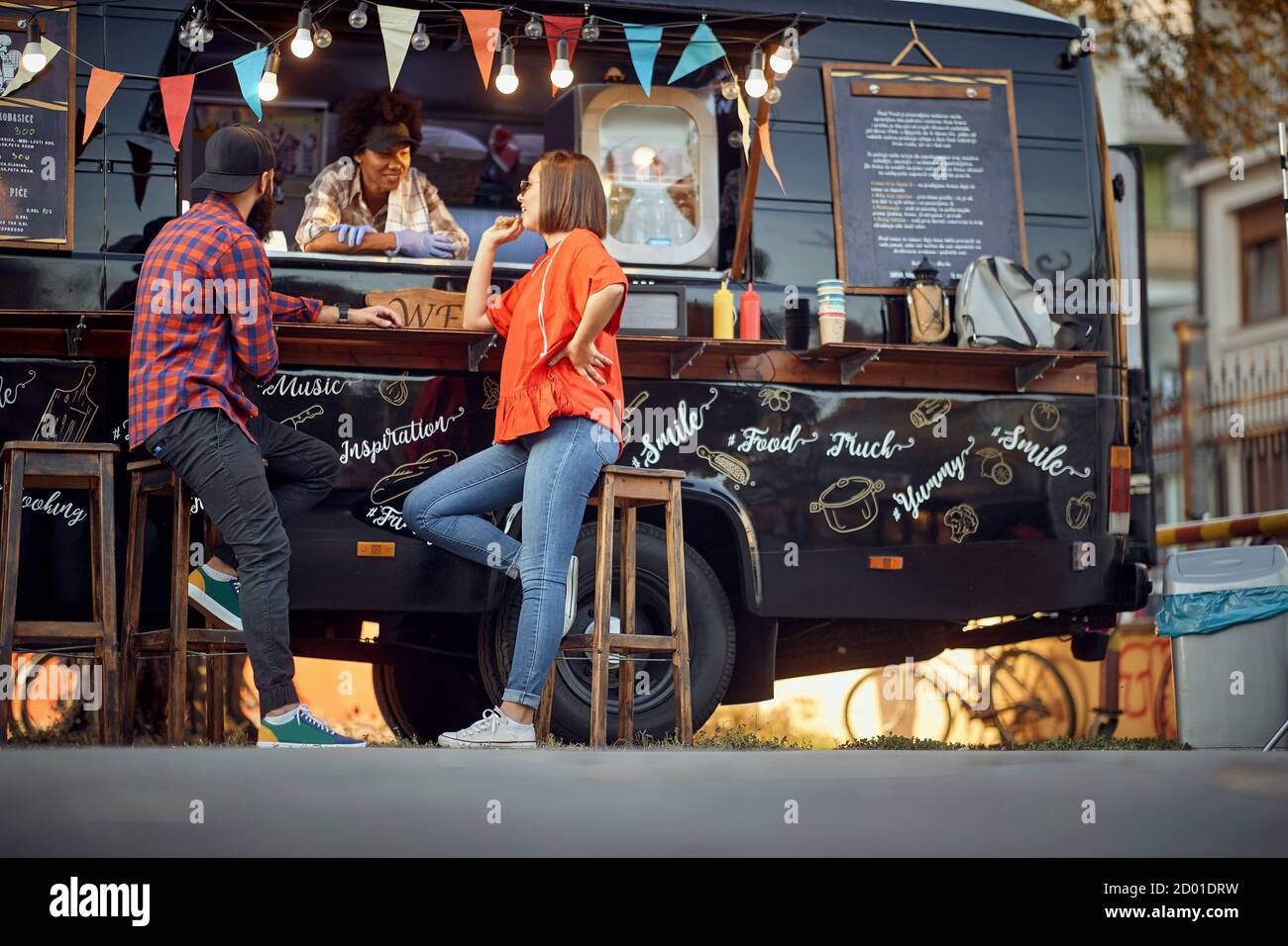 Afro american food truck employee taking orders from customers Stock Photo