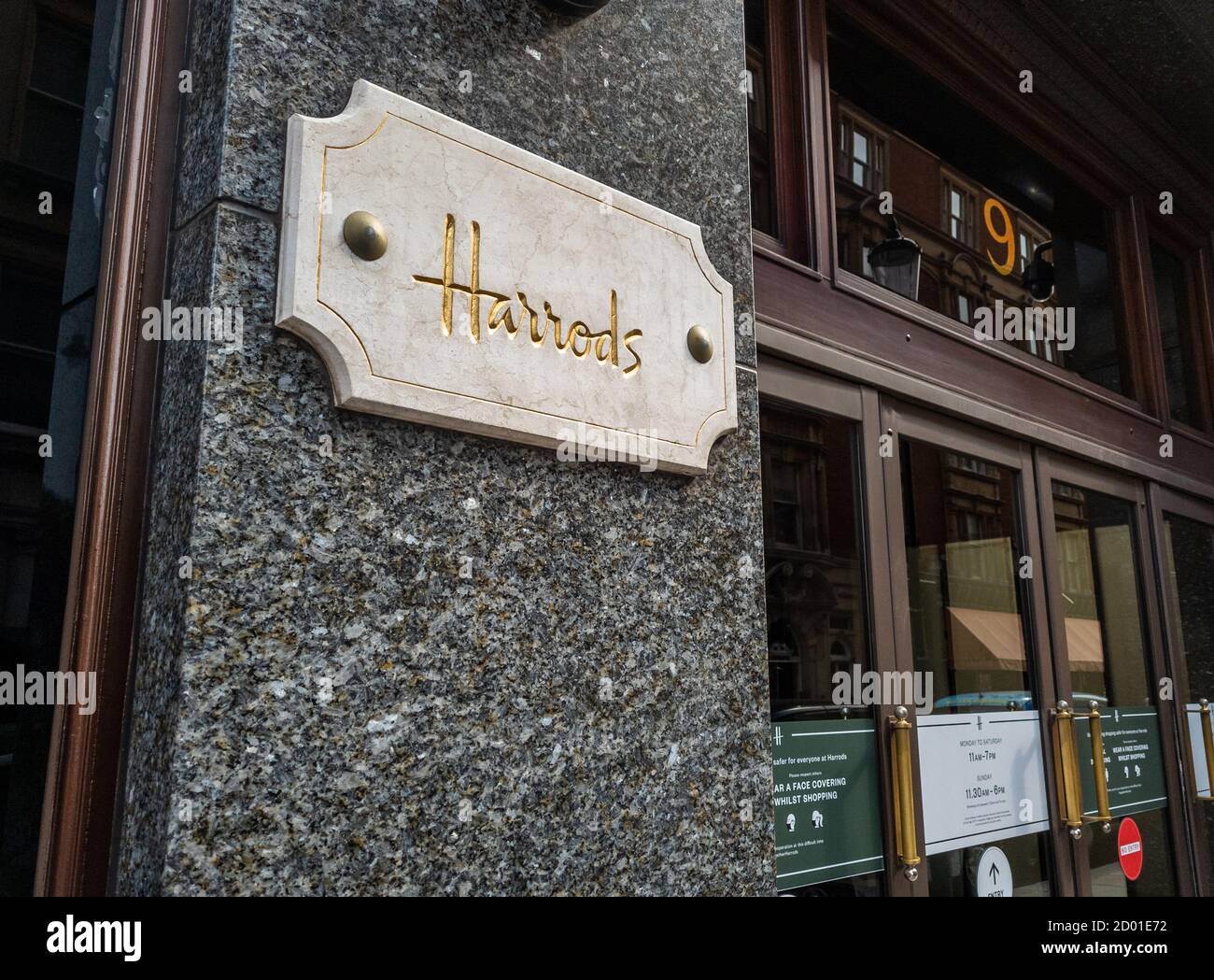 A name plate of Harrods by the entrance to the department store in