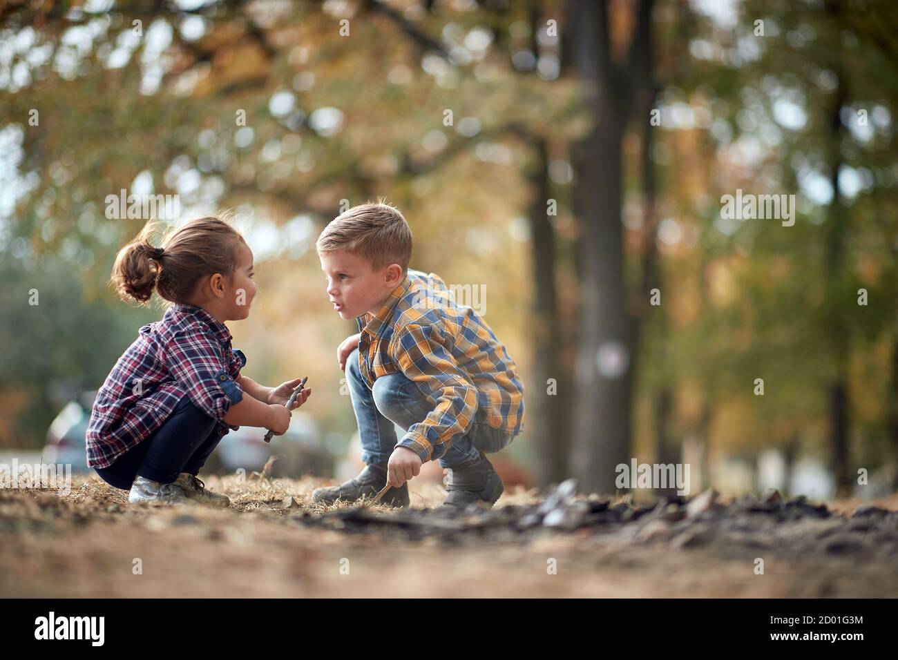 Preschool brother and sister playing in the woods together Stock Photo ...