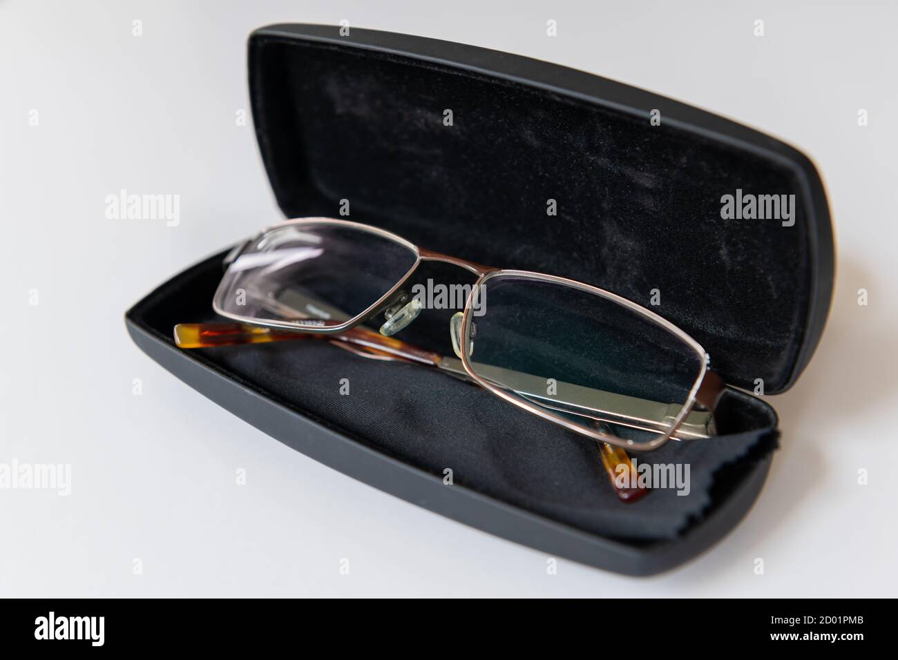 A pair of eye glasses and protective case isolated with a white background. Stock Photo