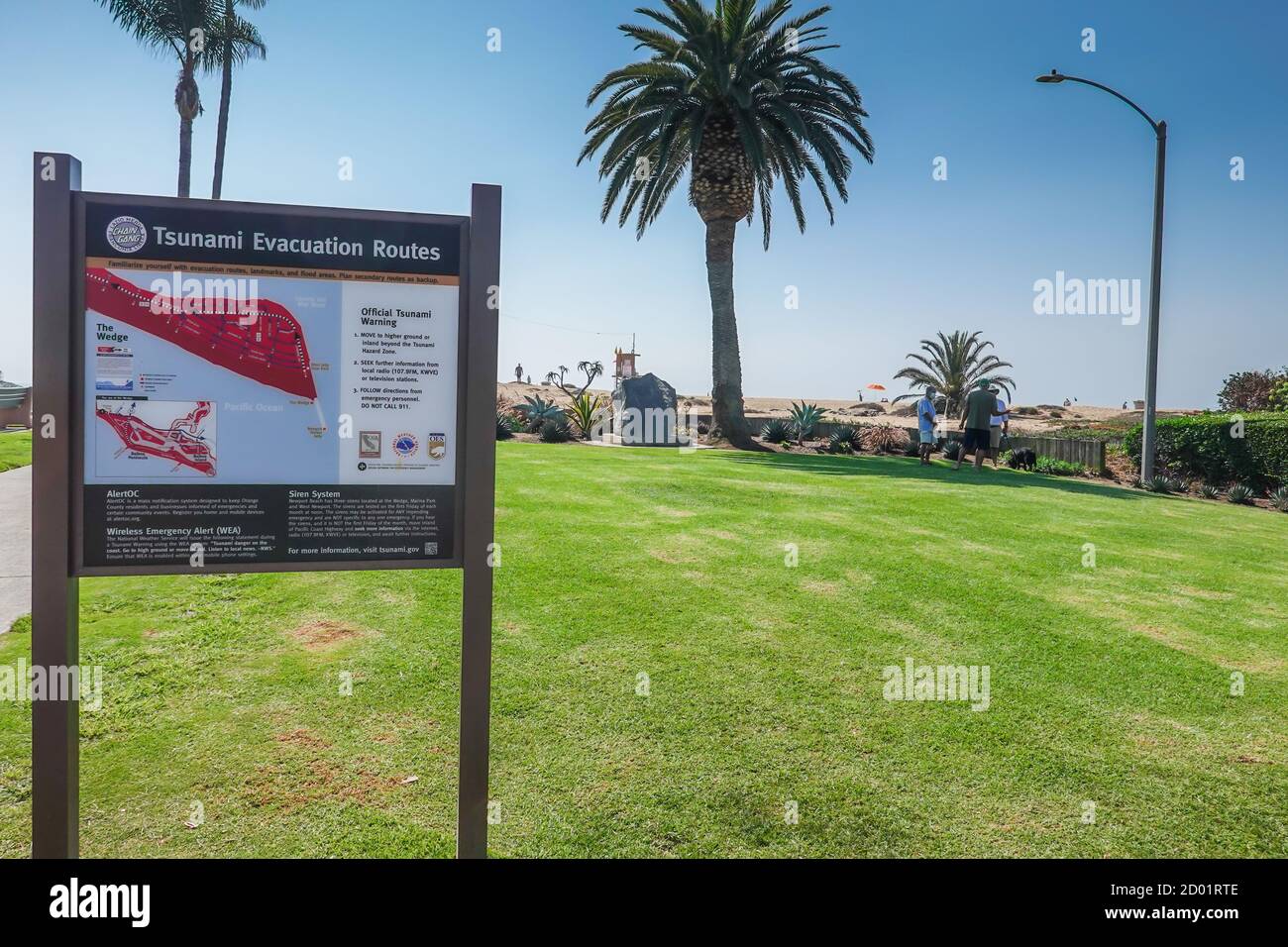 A tsunami evacuation routes sign and warning details on the balboa peninsular in Newport Beach  California  coast Stock Photo