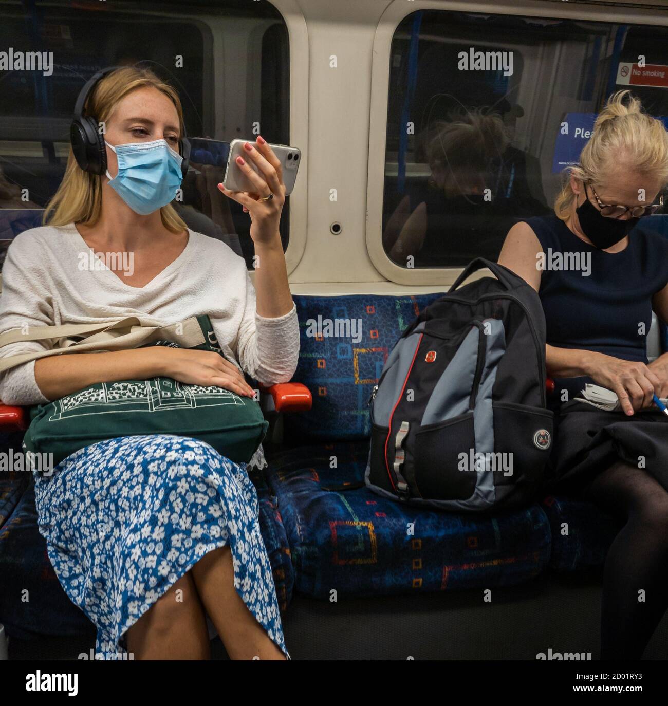 Passengers on London public transport social distancing. Stock Photo