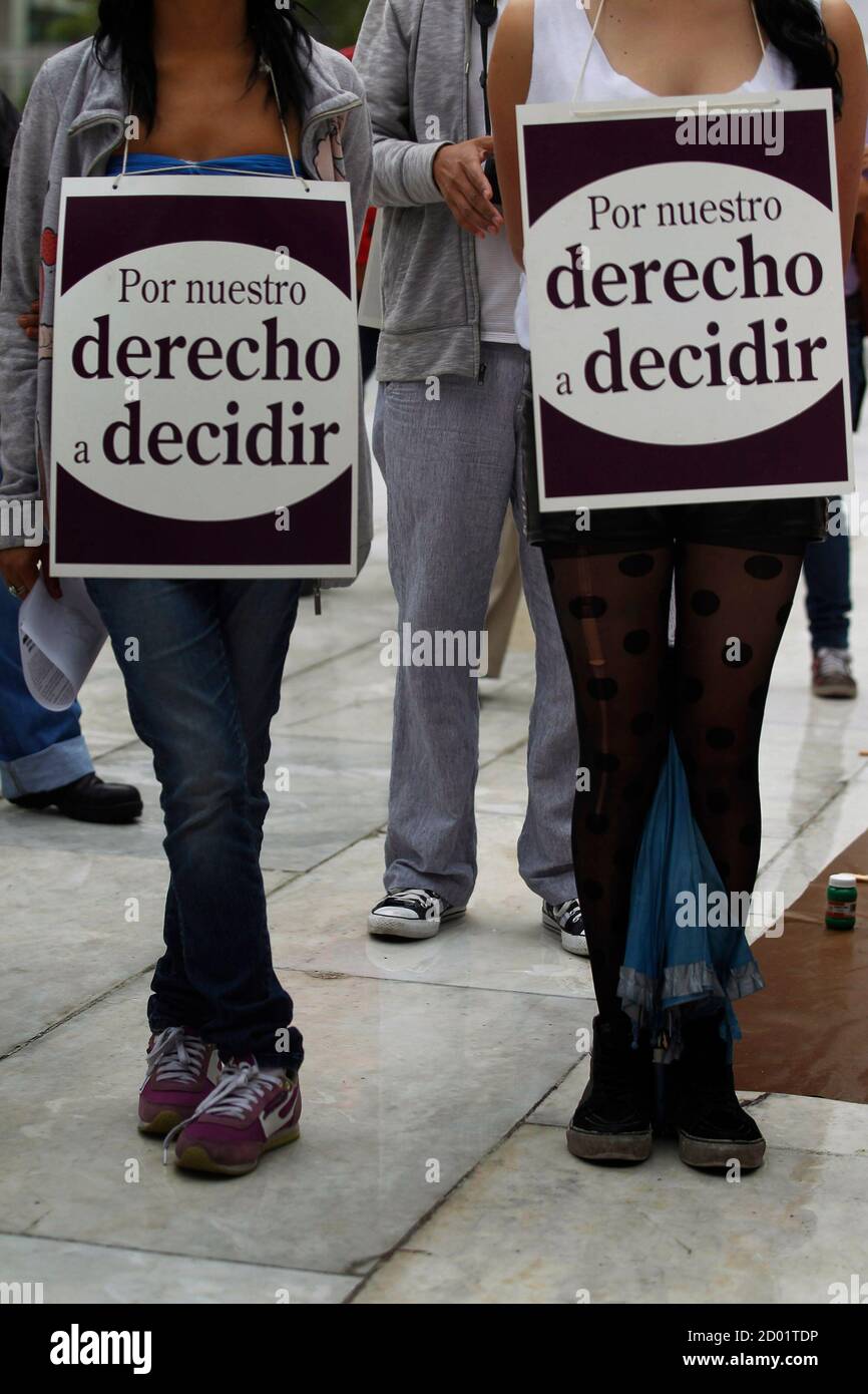 Two activists, each with a poster that reads, 'For our right to decide', take part in a demonstration in support of an 11-year-old Chilean girl, whose 32-year-old stepfather has been accused of raping her, in Mexico City July 25, 2013. The pregnancy of 'Belen', as she is known, has sparked an outcry in the Andean country, where abortion is banned under all circumstances. Abortion in Chile used to be allowed when pregnancies posed health risks, but was fully outlawed by the 1973-1990 Augusto Pinochet dictatorship, according to Human Rights Watch.    REUTERS/Edgard Garrido (MEXICO - Tags: SOCIET Stock Photo