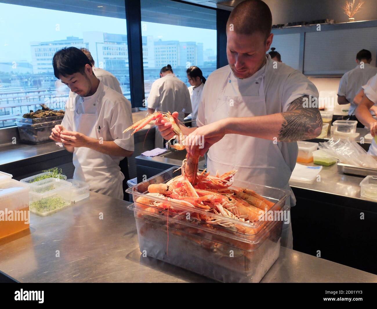 Chef Esben Holmboe Bang (2nd R) works in the kitchen of his restaurant  Maaemo in Oslo, September 9, 2014. In an unfashionable part of Oslo, head  chef Bang?s minimalist creations are stirring