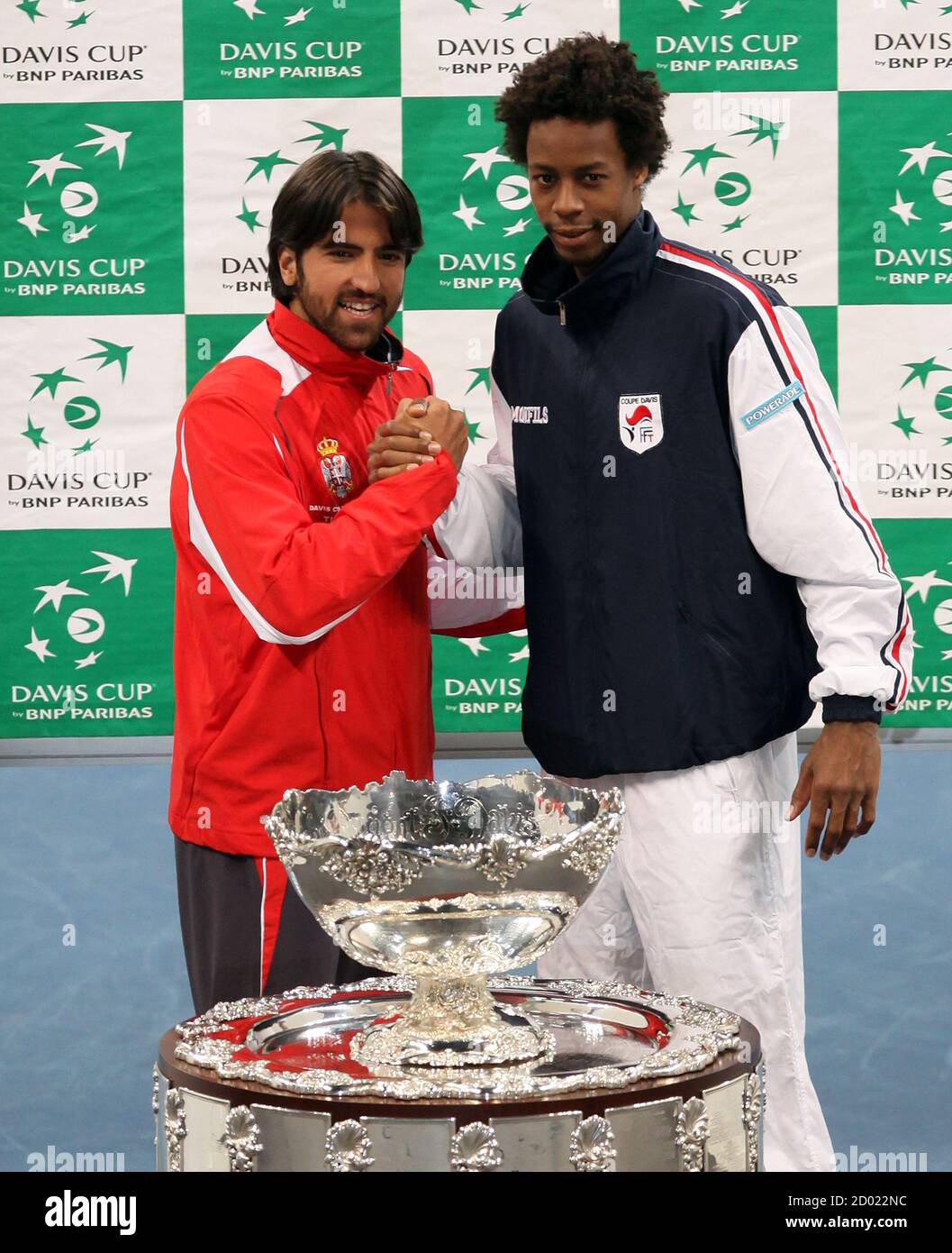 Serbia's Janko Tipsarevic (L) and France's Gael Monfils pose with the Davis Cup trophy after the official draw at Belgrade Arena in Belgrade December 2, 2010. Serbia and France will play their Davis Cup final tennis match from December 3-5 in Belgrade. REUTERS/Marko Djurica (SERBIA - Tags: SPORT TENNIS) Stock Photo
