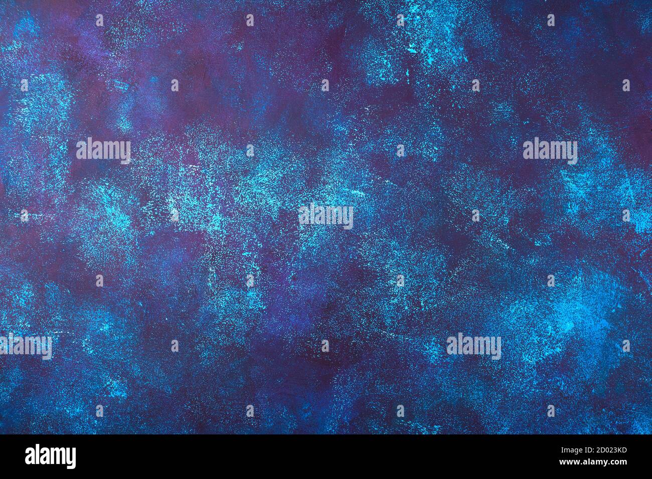 Dark blue concrete background with blue, maroon and white spots. Stock Photo