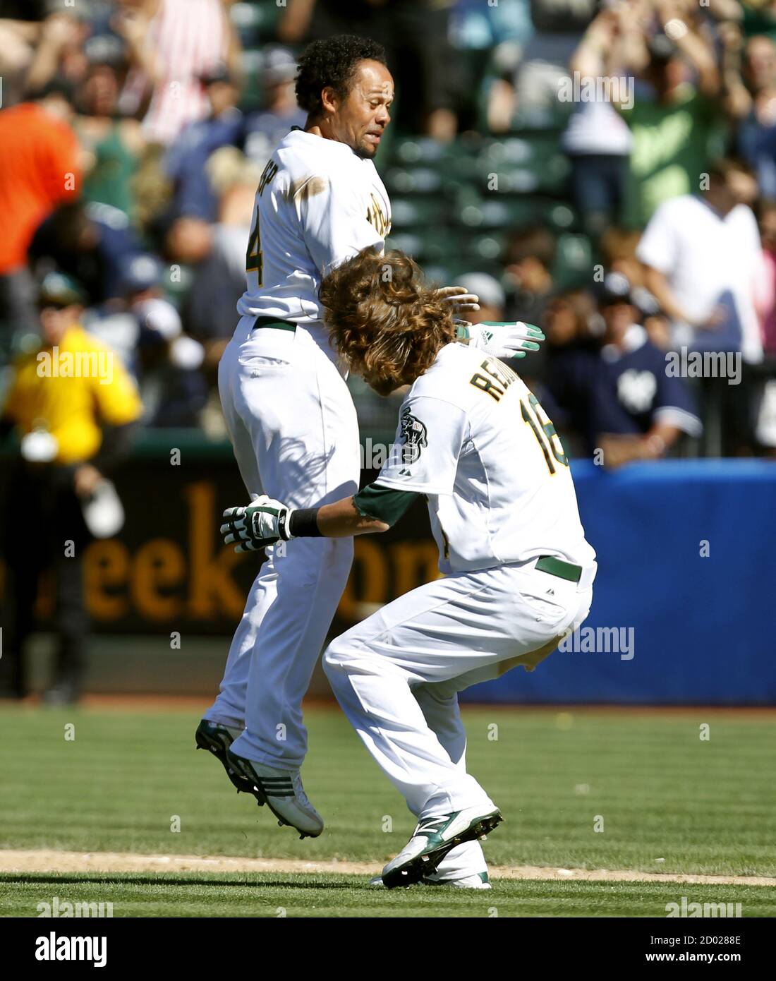 Oakland Athletics Coco Crisp L Leaps Into The Arms Of Teammate Josh Reddick After Crisp Drove Home The Game Winning Run Against The New York Yankees During The 12th Inning Of Their Mlb