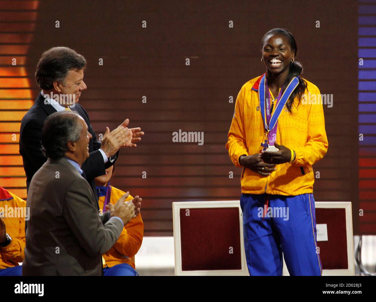 Caterine Ibarguen Silver Medallist In The Women S Triple Jump Event At The London 2012 Olympic Games Is Applauded By President Juan Manuel Santos L Top After Being Decorated With The Order Of