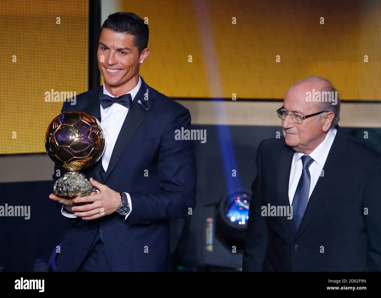 Real Madrid's Cristiano Ronaldo of Portugal, holds his World Player of the  Year trophy as he stands next to FIFA President Sepp Blatter (R) during the  FIFA Ballon d'Or 2014 soccer awards