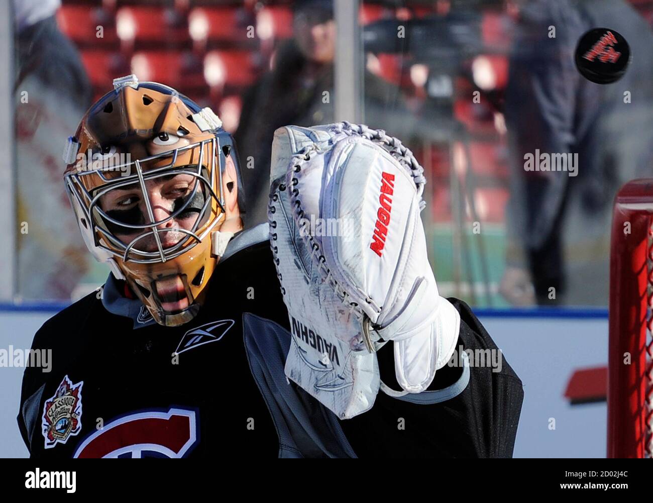 Montreal Canadiens Goalie Carey Price Deflects The Puck While Wearing His New Face Mask During Their Team Practice In Preparation For The Nhl Heritage Classic Hockey Game At The Outdoor Arena Of
