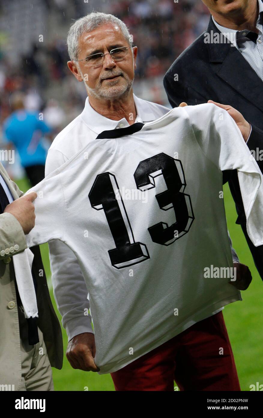 German soccer legend Gerd Mueller holds up his jersey before a friendly  soccer match between Bayern Munich and the Netherlands in Munich May 22,  2012. Mueller used the jersey during West Germany's