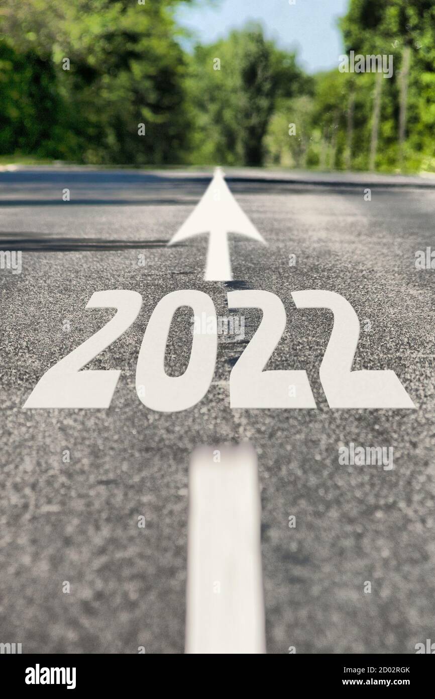 Road to 2022 year. Asphalt road with road markings and 2022 sign. Direction to the future 2022 year Stock Photo