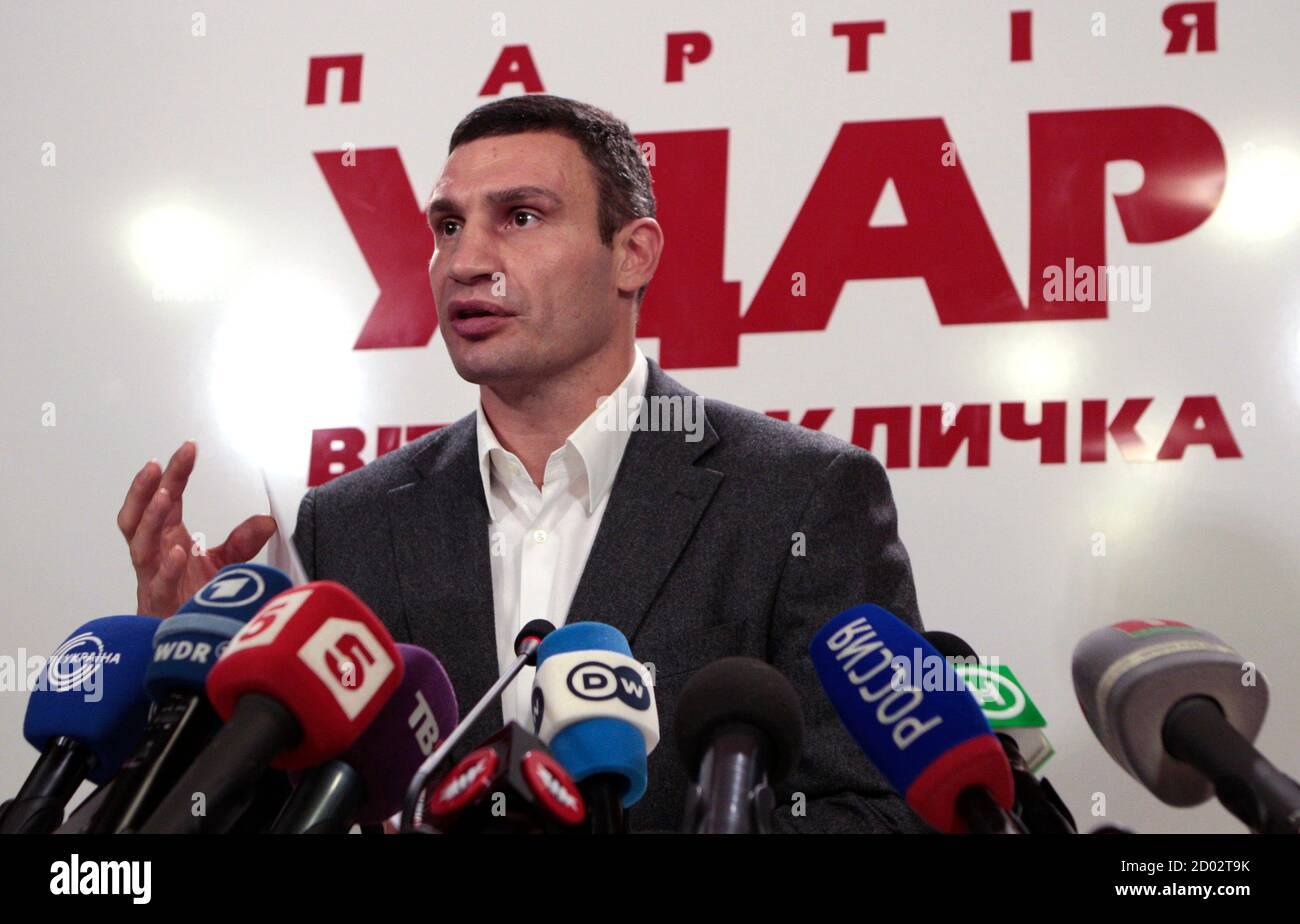 Heavyweight boxing champion and UDAR (Punch) party leader Vitaly Klitschko speaks at his party's election headquarters in Kiev, October 28, 2012. Ukrainian President Viktor Yanukovich's pro-business ruling party led in a national election on Sunday and seemed likely to keep its majority in parliament, exit polls showed, despite a strong showing by the combined opposition. The sign reads: ' Vitaly Klitschko's UDAR (Punch) party'.    REUTERS/Vasily Fedosenko (UKRAINE - Tags: SPORT BOXING POLITICS ELECTIONS) Stock Photo