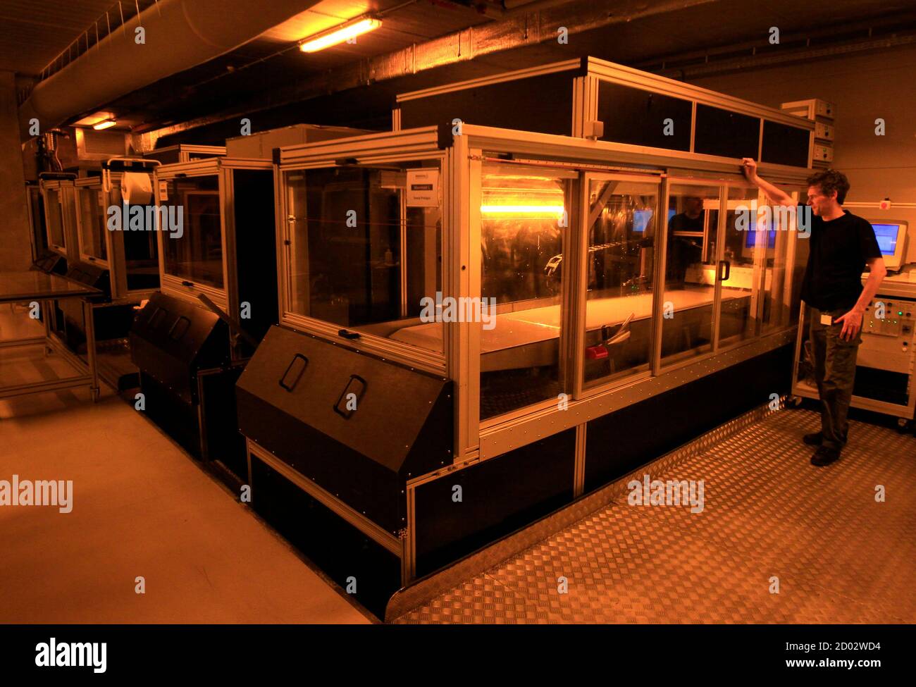 A technician at Belgian company Materialise, the biggest 3D printer in  Europe, operates a Materialise patented Mammoth stereolithography machine,  capable of printing parts of up to 2100x680x800mm in one piece, to create