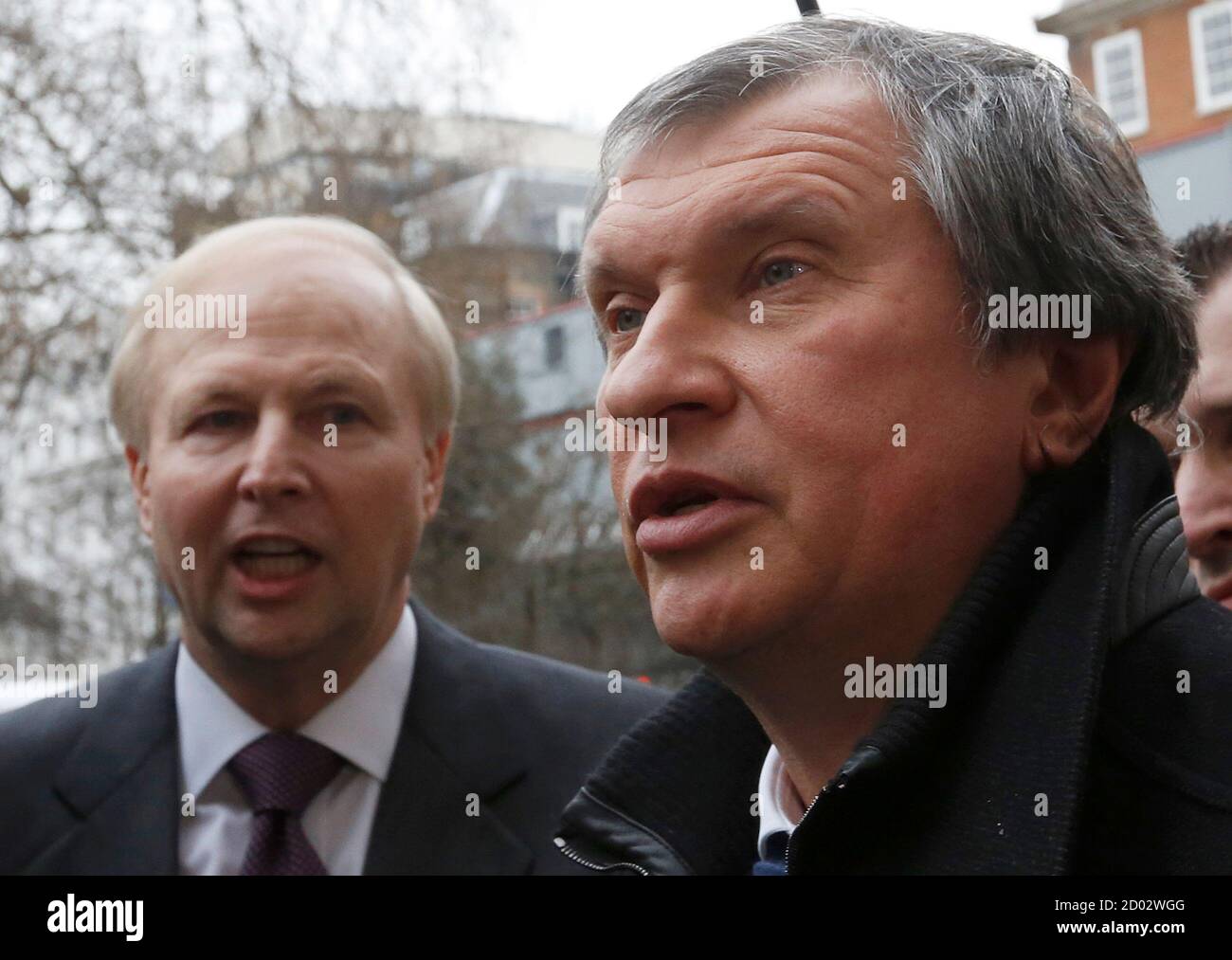 British Petroleum CEO Bob Dudley and Rosneft CEO Igor Sechin (R) speak to journalists as they arrive outside the BP headquarters in central London March 21, 2013. Russian state oil company Rosneft closed its deal to buy TNK-BP from UK-based BP and four tycoons on Thursday, releasing $40 billion cash to the sellers and becoming a bigger oil producer than Exxon Mobil. The $55 billion deal, which also gives BP a near 20 percent stake in Rosneft, was announced last year after months of on-off negotiations. It is the biggest in Russia's corporate history.. REUTERS/Olivia Harris (BRITAIN - Tags: BUS Stock Photo