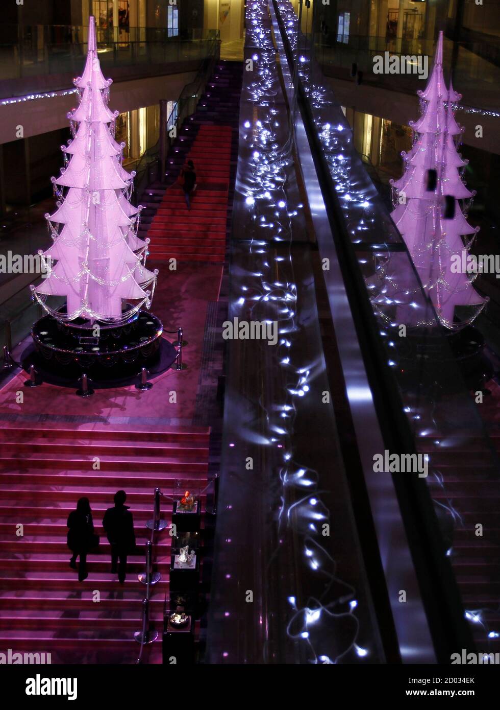 A Couple Walks Towards A Christmas Tree At A Shopping Mall In Tokyo November 24 2010 Retailers Across Australia And Japan Are Bracing For Tight Fisted Shoppers To Hold Out For Bargains