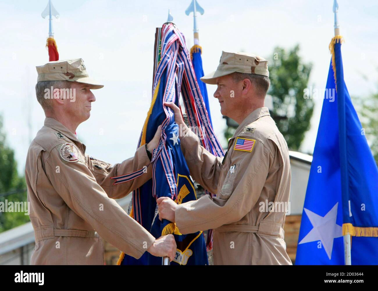 Mike Hostage (L), commander of the U.S. Air Force Central Command, Southwest Asia, and Colonel James Jacobson take part in the change of command ceremony at the U.S. transit center at Manas airport near Bishkek June 14, 2011. Sones relinquished command of the 376th Air Expeditionary Wing to Jacobson on Tuesday. REUTERS/Vladimir Pirogov  (KYRGYZSTAN - Tags: POLITICS MILITARY) Stock Photo