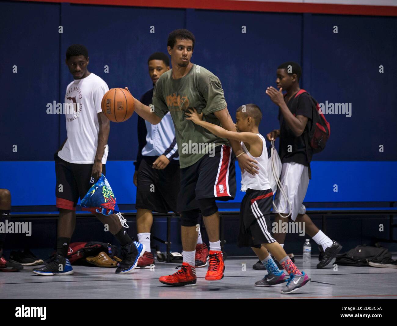 Downey Christian high school varsity basketball player 11-year-old Julian  Newman (2nd R) reaches for the ball during Friday evening pickup basketball  games at Downey Christian School in Orlando, Florida February 22, 2013.