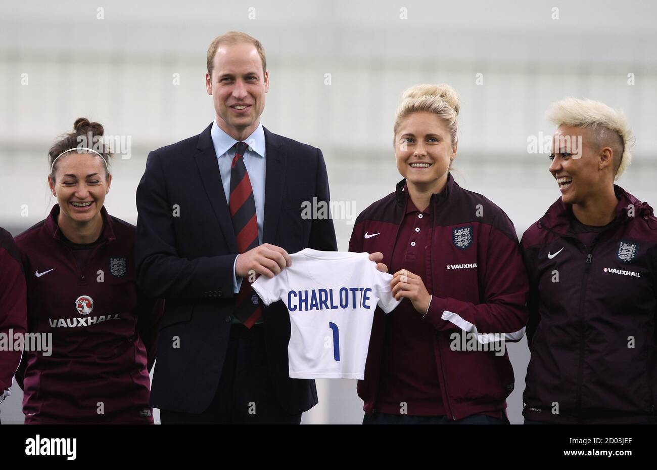Britain's Prince William holds a shirt with his new daughter's name during a visit to the England ladies soccer World Cup squad at St George's Park, Burton, Britain, May 20, 2015.  REUTERS/Bradley Ormesher/Pool Stock Photo