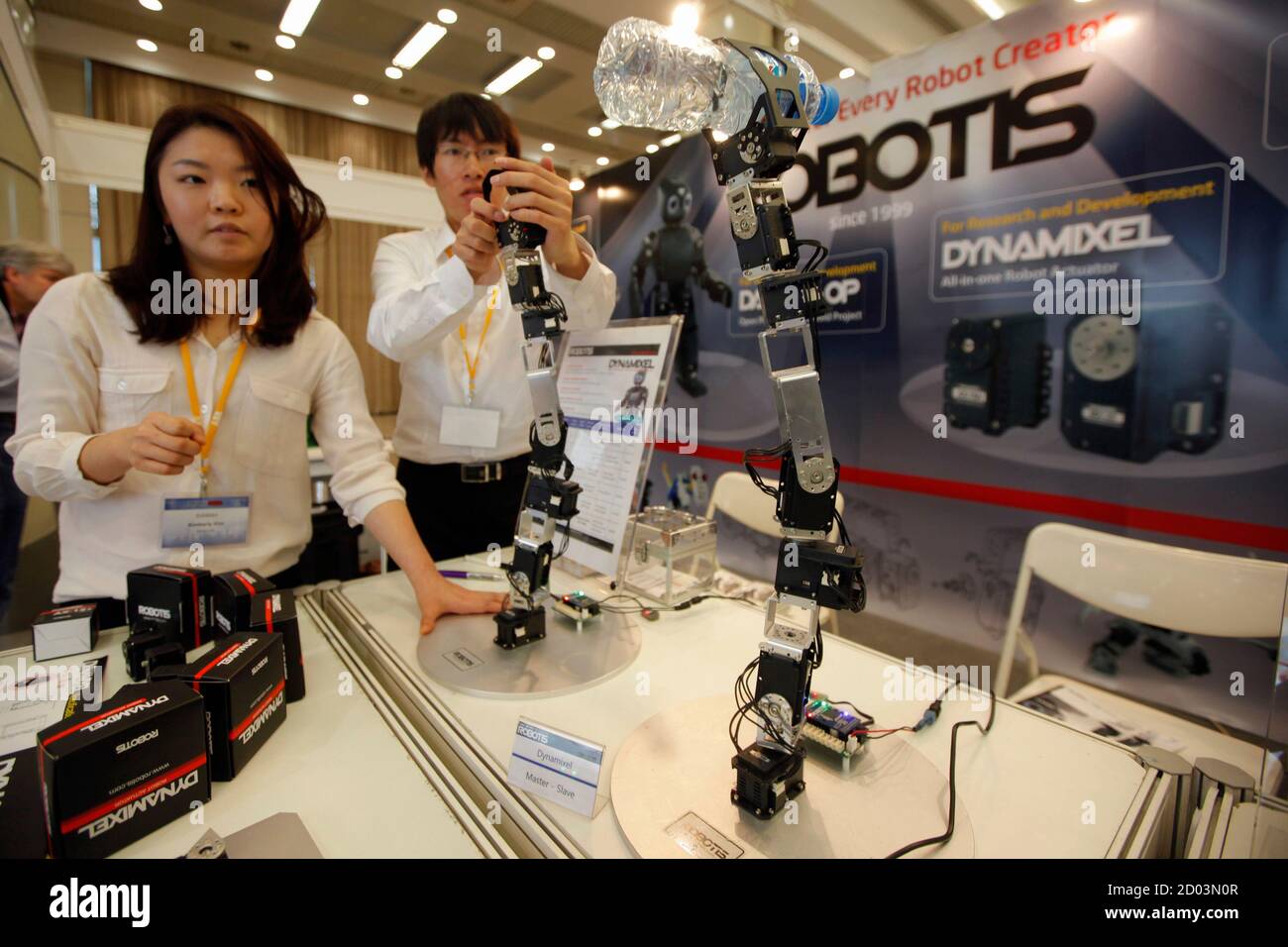 People look at a demonstration of a prototype pair of hand robots during the 2011 IEEE International Conference on Robotics and Automation (ICRA 2011) in Shanghai May 11, 2011. The theme of the conference is 'Better Robots, Better Life' and it runs from May 9-13. REUTERS/Aly Song  (CHINA - Tags: SOCIETY SCI TECH) Stock Photo