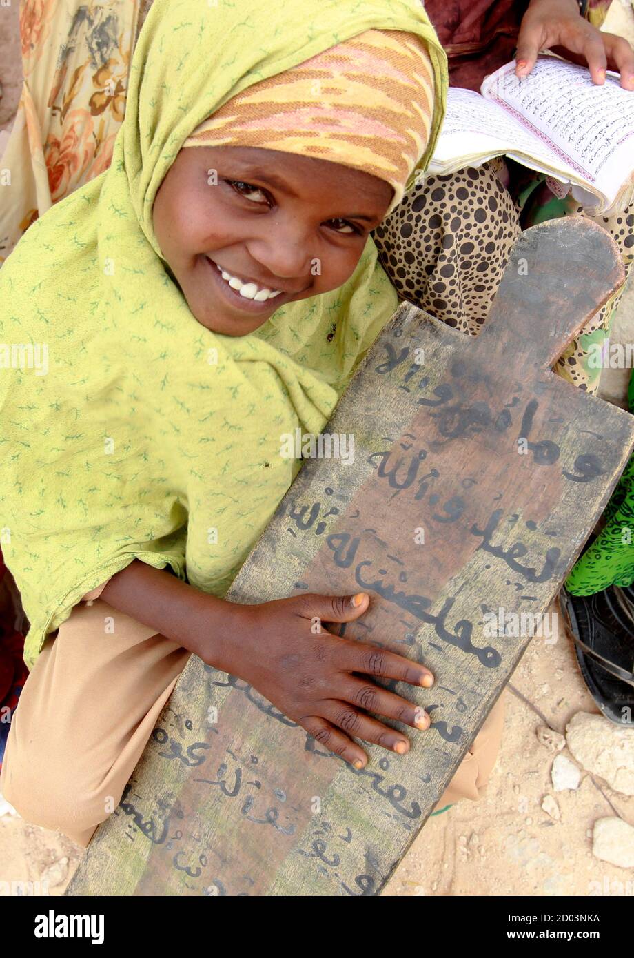 An internally displaced Somali girl attends classes at a Muslim Madrasah (Islamic school) outside a makeshift classroom at the Halabokhad IDP settlement in Galkayo, northwest of Somalia's capital Mogadishu, July 20, 2011. Galkayo hosts over 60,000 internally displaced Somalis in 21 settlements and there are always new arrivals due to the prolonged drought. The United Nations on Wednesday declared famine in two regions of southern Somalia, and warned that this could spread further within two months in the war-ravaged Horn of Africa country unless donors step in. REUTERS/Thomas Mukoya (SOMALIA - Stock Photo