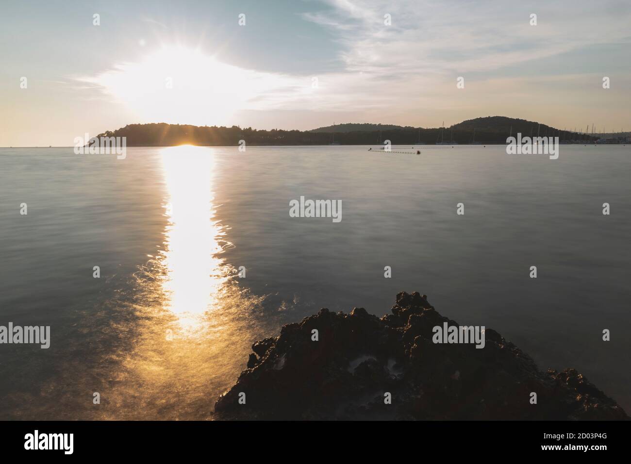 Long exposure of Rogoznica town bay photographed during magnificent sunset, creating silky water effect Stock Photo