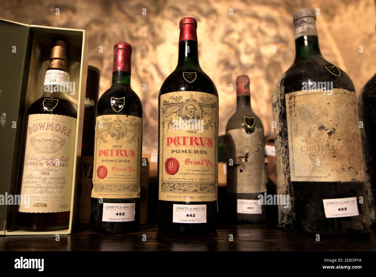 From L-R, a vintage bottle of 1969 Single Malt Bowmore scotch whisky, a  1972 Chateau Petrus, a magnum 1964 Chateau Petrus, a 1936 Chateau Mouton- Rothschild and a 1970 double magnum Chateau Haut-Brion,