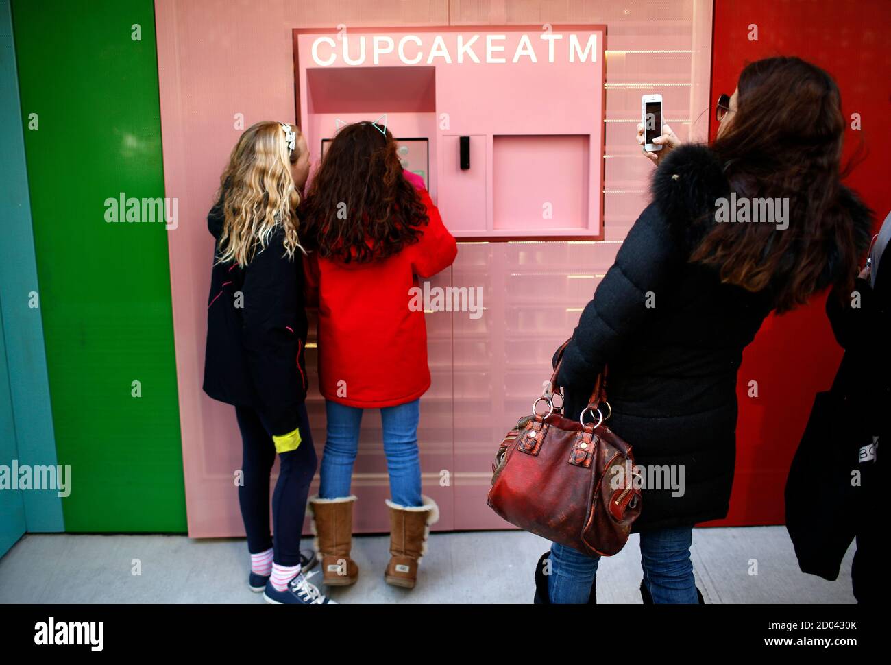 Girls make a selection from the Cupcake ATM at Sprinkles Cupcake Bakery