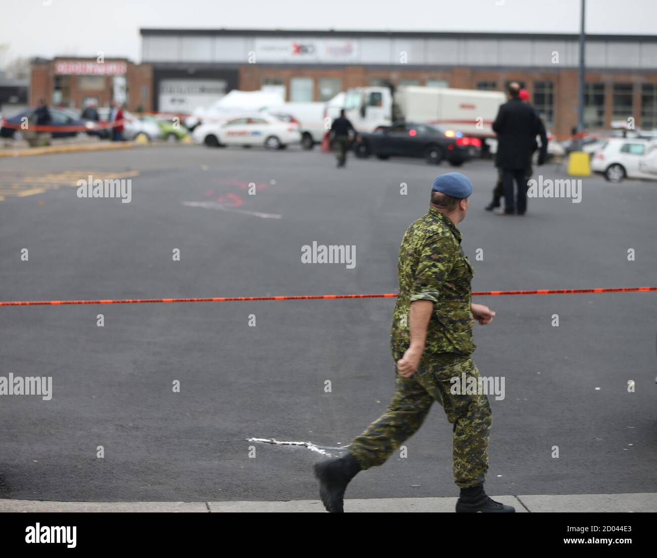 A member of Canada's armed forces walks past the scene of a hit and run of  two soldiers in St. Jean sur Richelieu, Quebec, October 20, 2014. One of  two Canadian soldiers