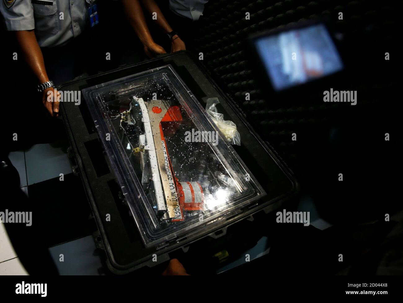 The flight data recorder from AirAsia QZ8501 is placed into a container at the National Transportation Safety Committee office in Jakarta January 12, 2015. Indonesian navy divers retrieved the black box flight data recorder from the wreck of the AirAsia passenger jet on Monday, a major step towards unravelling the cause of the crash that killed all 162 people on board. Flight QZ8501 lost contact with air traffic control in bad weather on Dec. 28, less than halfway into a two-hour flight from Indonesia's second-biggest city of Surabaya to Singapore. REUTERS/Beawiharta (INDONESIA - Tags: DISASTE Stock Photo