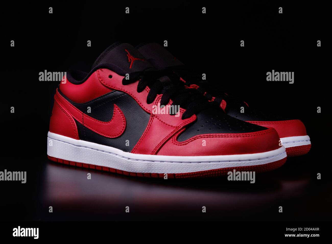 Nike Air Jordan 1 Retro Low Reverse Bred colorway sneakers on black  background illustrative editorial Stock Photo - Alamy