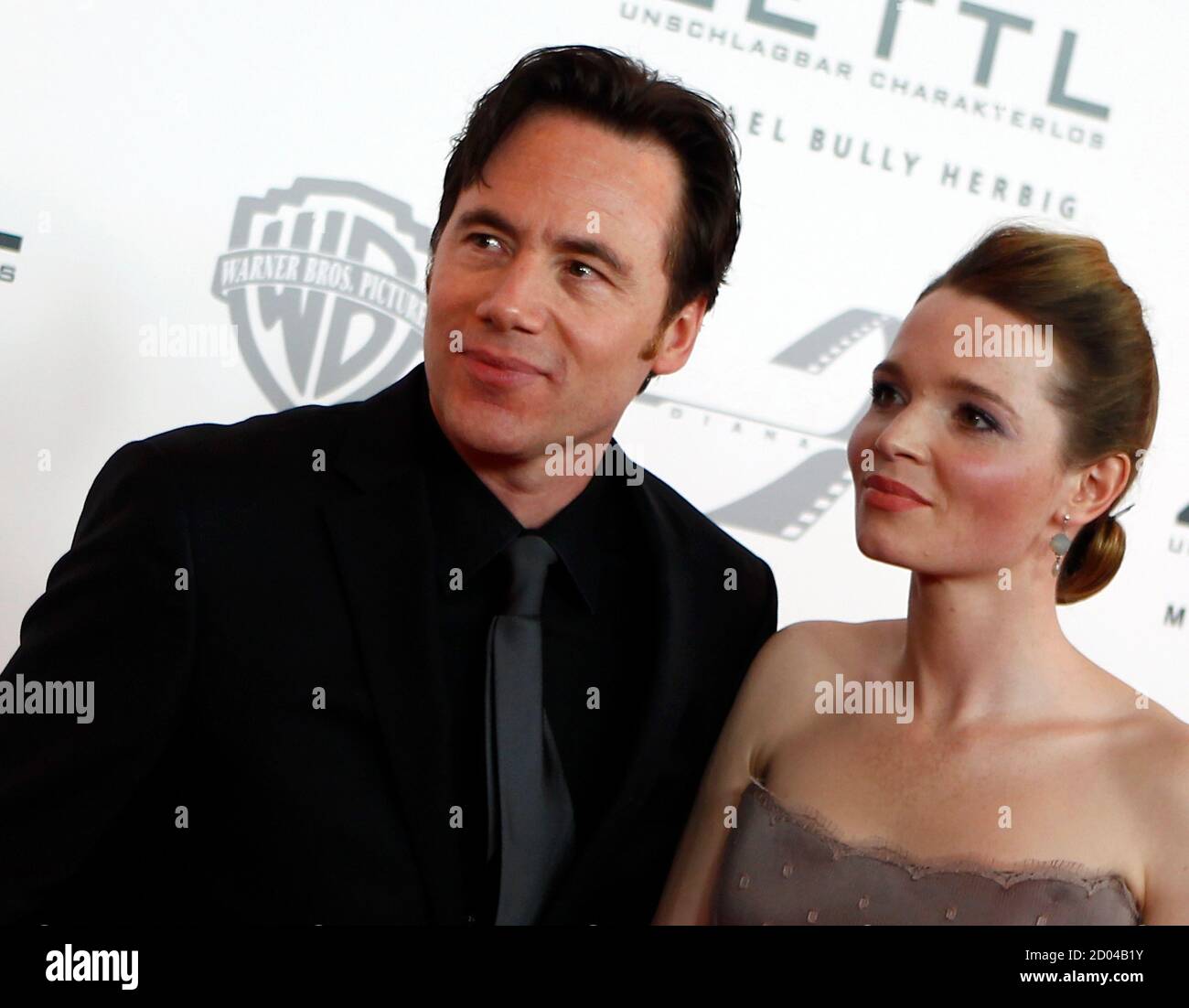 Actor Michael 'Bully' Herbig and actress Karoline Herfurth arrive on the red carpet for the screening of German director Helmut Dietl's movie 'Zettl' in Munich January 31, 2012.   REUTERS/Michael Dalder  (GERMANY - Tags: ENTERTAINMENT) Stock Photo
