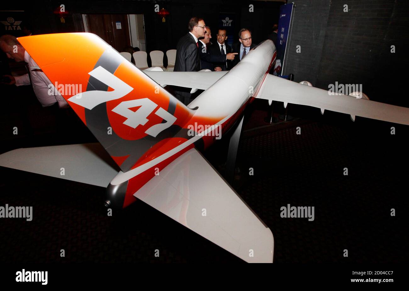 Delegates of the 68th International Air Transport Association (IATA) annual general meeting look at a model of new Boeing 747 aircraft, in Beijing June 10, 2012. Demand for premium seats on passenger jets is widely seen as a barometer of business confidence, while broader passenger traffic tracks broader trends in gross domestic product. Airlines from the 240-member International Air Transport Association (IATA) will be tackling growing regional disparities in demand amid Europe's financial turmoil as they gather for an annual meeting in Beijing this weekend. REUTERS/Jason Lee (CHINA - Tags: T Stock Photo