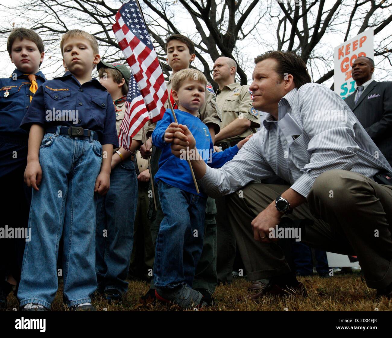 Steve Mitschke and his sons Wyatt (C), 4, and Zach (2nd L), 6, participate  in a prayer vigil at the Boy Scouts of America headquarters in Irving,  Texas, February 6, 2013. Mitschke