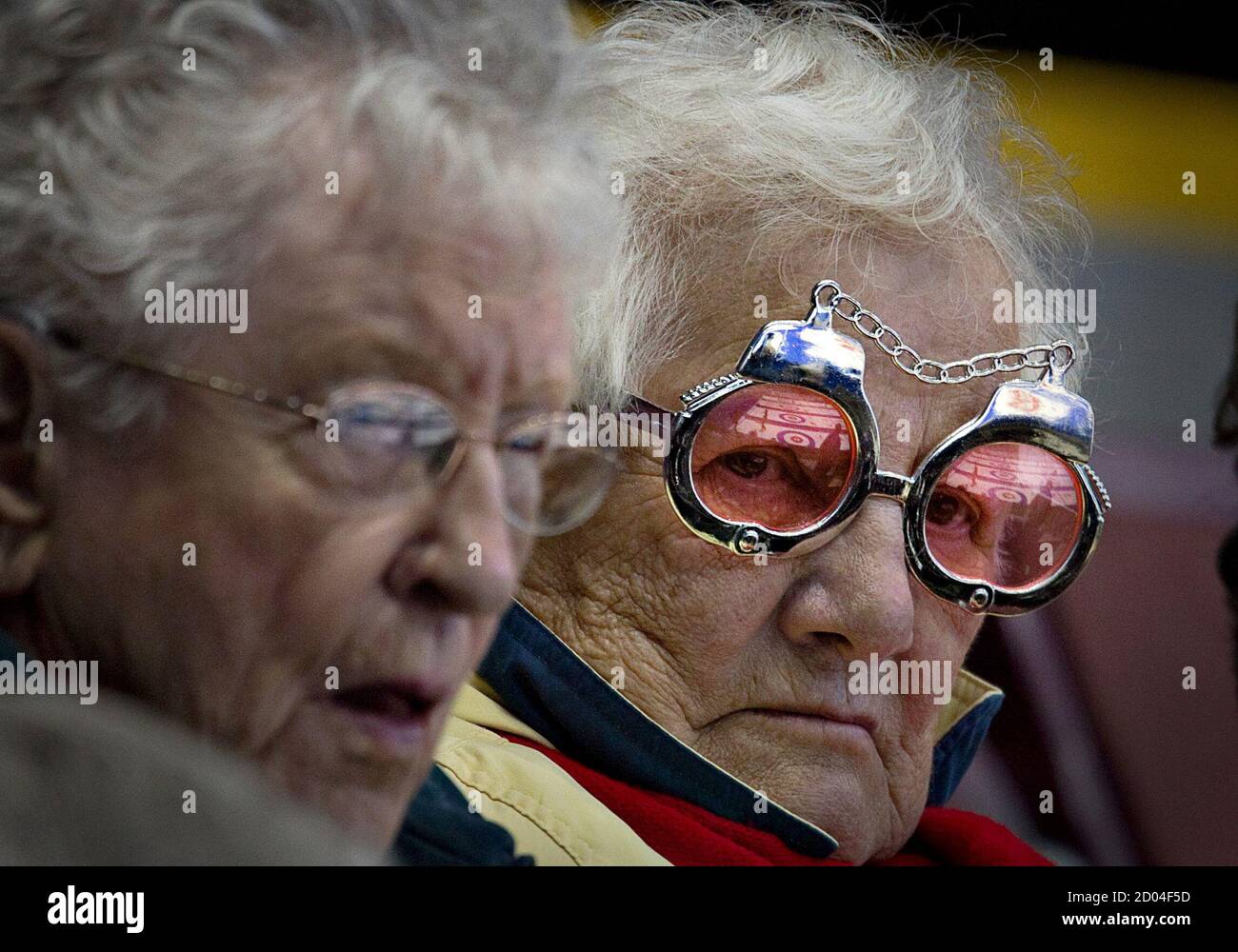 Curling fan Audrey Jasper wears sunglasses designed like handcuffs while  attending the World Men's Curling Championships in Victoria, British  Columbia April 2, 2013. When asked why she wore sunglasses of that  particular