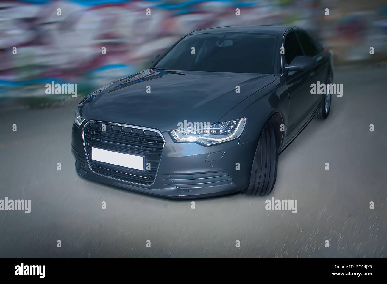 dark car near wall with graffiti Stock Photo