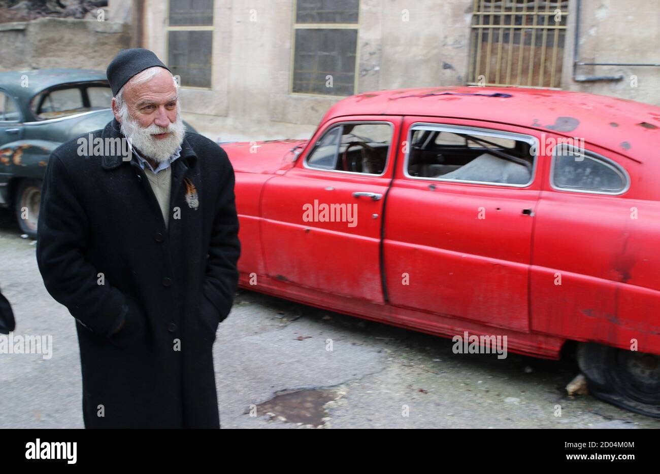 Mohamed Badr Al Din Stands In Front Of One Of His Cars Along A Street Where He Keeps Them In The Al Shaar Neighborhood Of Aleppo January 31 2015 The 66 Year Old Collector Nicknamed Abu