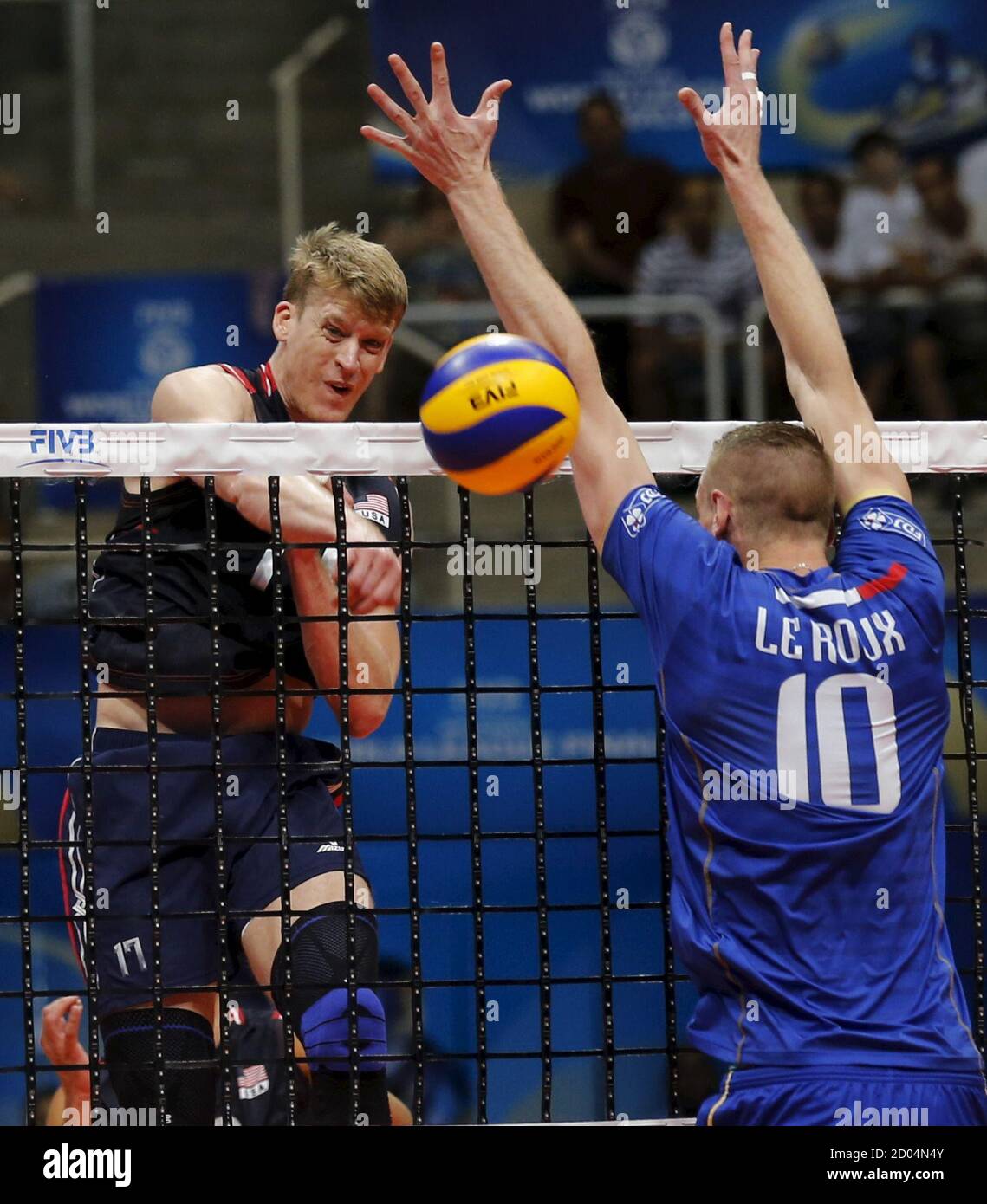 Maxwell Holt (L) of the U.S. spikes the ball against Kevin Le Roux of  France during their FIVB Men's Volleyball World League final round group  match in Rio de Janeiro, Brazil, July