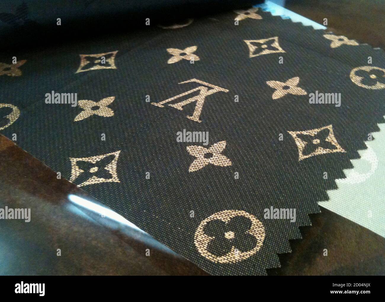 A piece of fake Louis Vuitton material is seen at Shiling Zhen leather  market in the southern Chinese city of Guangzhou September 30, 2010. The  Organization for Economic Cooperation and Development estimates