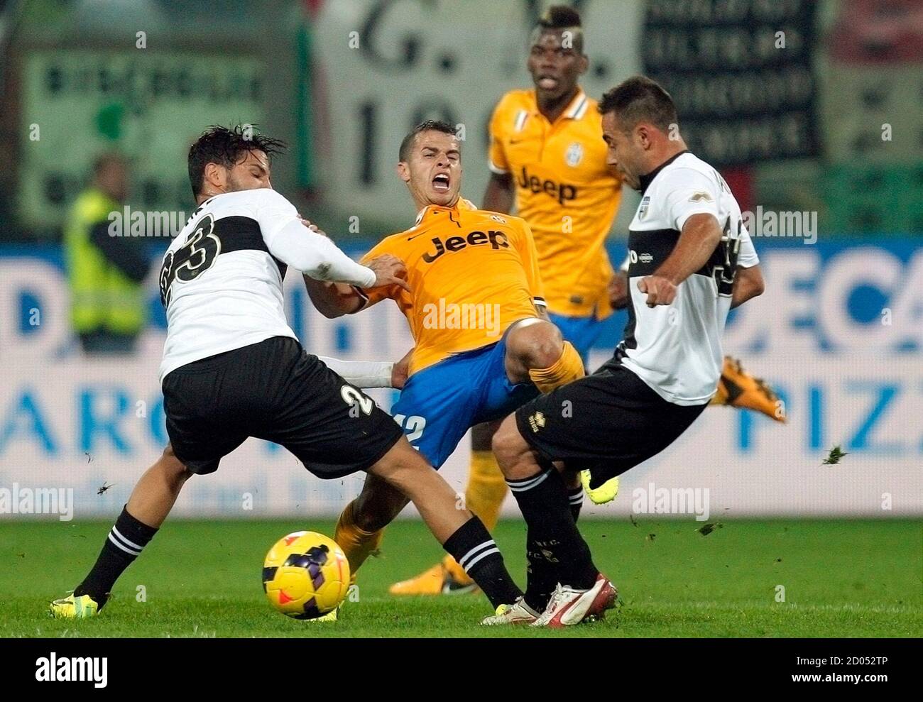 Juventus' Sebastian Giovinco (2nd L) fights for the ball with Parma's Pedro Mendes (L) and Marco Marchionni during their Italian Serie A soccer match at Tardini stadium in Parma November 2, 2013. REUTERS/Alessandro Garofalo (ITALY - Tags: SPORT SOCCER) Stock Photo