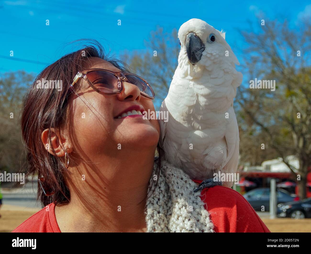 White cockatoo and southeast asian woman posing for a photo. Stock Photo