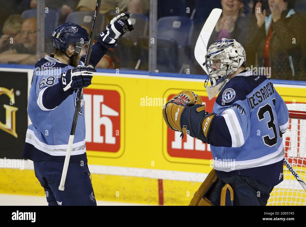 Rimouski Oceanics Guillaume McSween (68) and goalie Philippe Desrosiers celebrate their victory against the Quebec Remparts during their Memorial Cup hockey game at the Colisee Pepsi in Quebec City, May 27, 2015. REUTERS/Mathieu Belanger Stock Photo