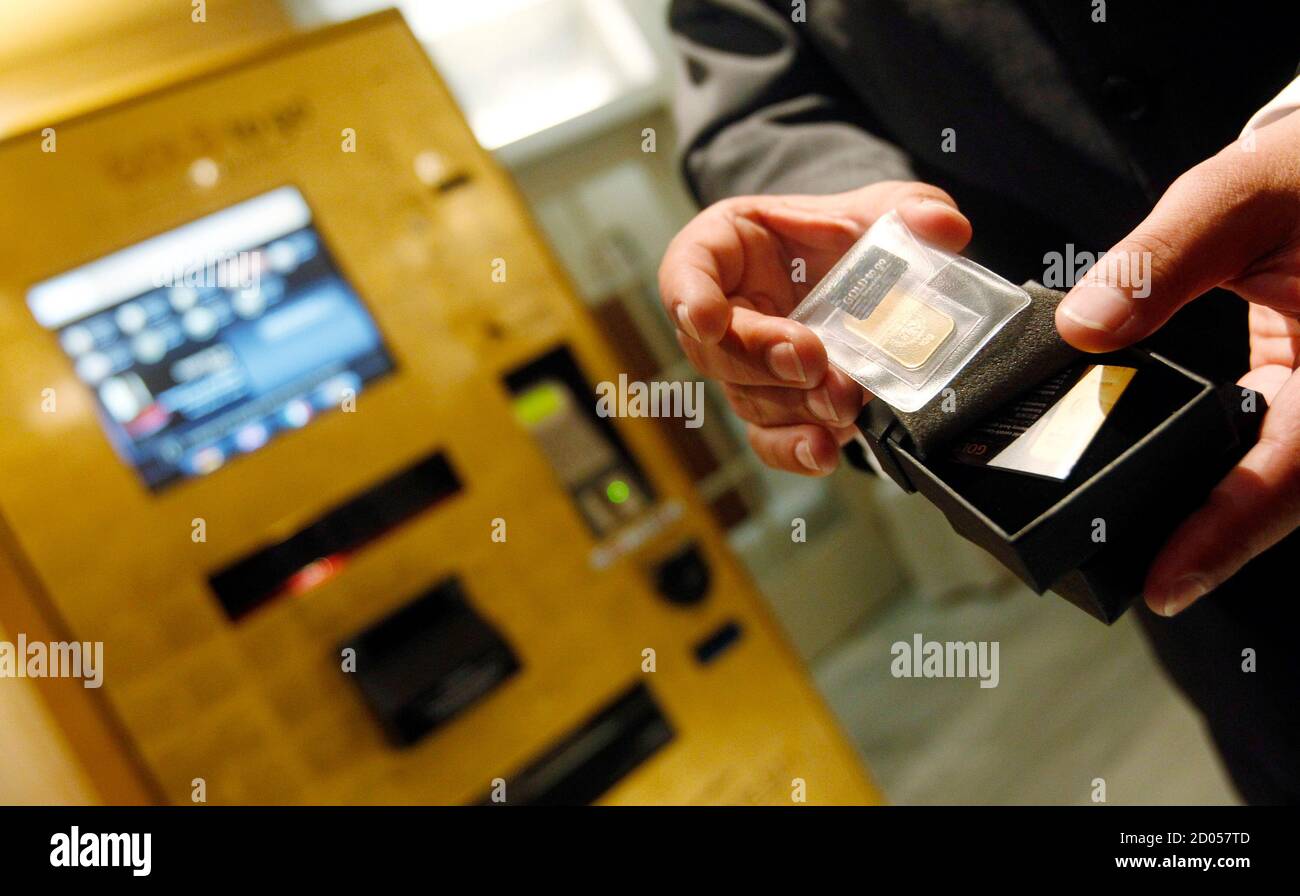 Ex Oriente Lux Ceo Thomas Geissler Holds A Gold Coin After Unveiling The First Gold Plated Atm Automated Teller Machine In Europe At A Madrid S Luxury Hotel September 23 2010 The Machine Which