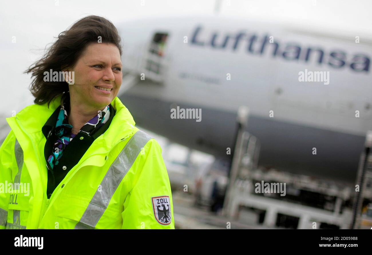 Germany's Consumer Protection Minister Ilse Aigner wears the jacket of a  German custom officer during her visit at Frankfurt's airport, March 30,  2011. Aigner visited Frankfurt's custom authorities who are responsible for