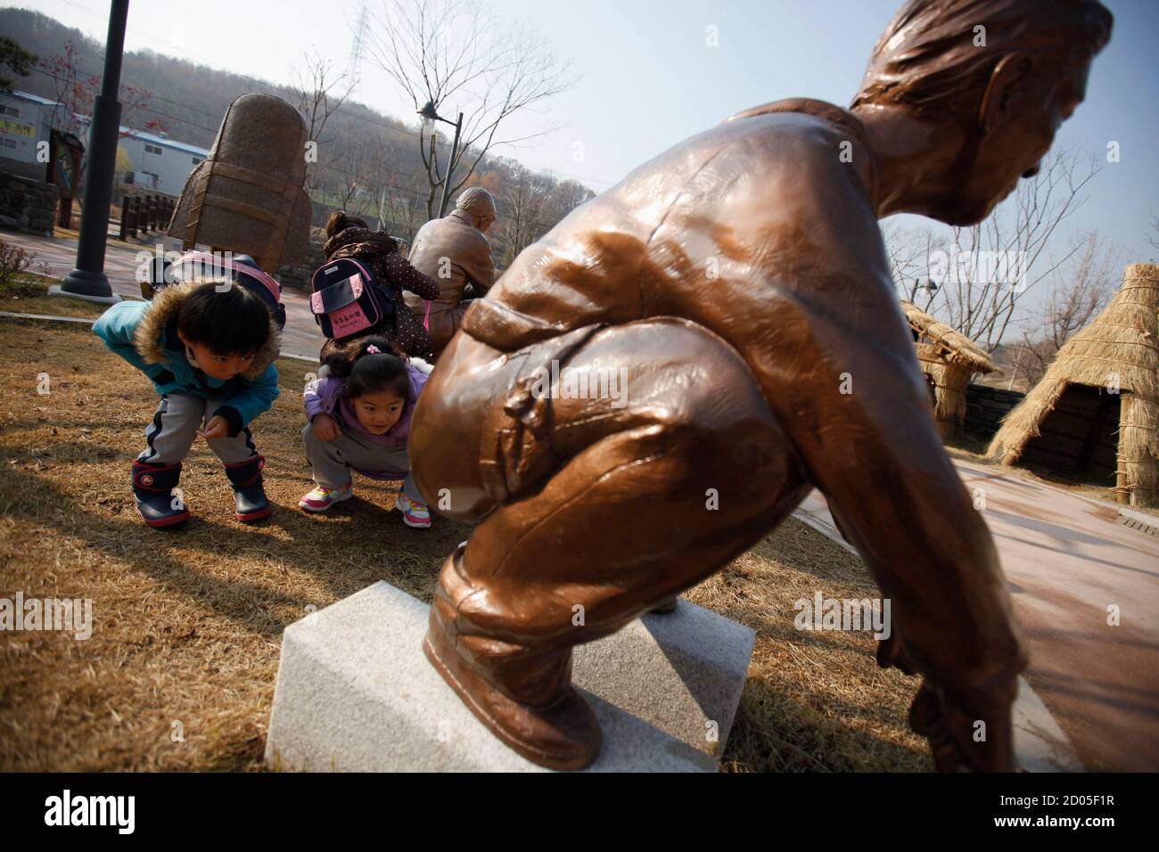 at a statue of a man responding to the call of nature at the Toilet Culture Park in Suwon, about 46 km (29 miles) south of Seoul, November 22,