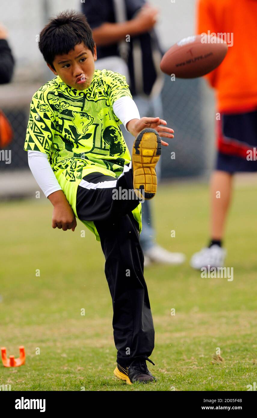 Seven-year-old Jarom Alani of Captain Cook, Hawaii punts the ball in the Punt, Pass & Kick competition prior to the Cincinnati Bengals playing against the San Diego Chargers in their NFL football game in San Diego, California December 2, 2012.  Punt, Pass & Kick competition in five age gendered groups with the top scorer in each group crowned team champion, the top four scorers from all the teams compete for the National Championships to be held during an NFC playoff game.   REUTERS/Alex Gallardo (UNITED STATES - Tags: SPORT FOOTBALL) Stock Photo