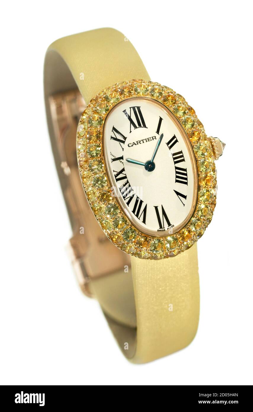 Gold Cartier women's watch with roman numerals and jewel encrusted face photographed on a white background Stock Photo